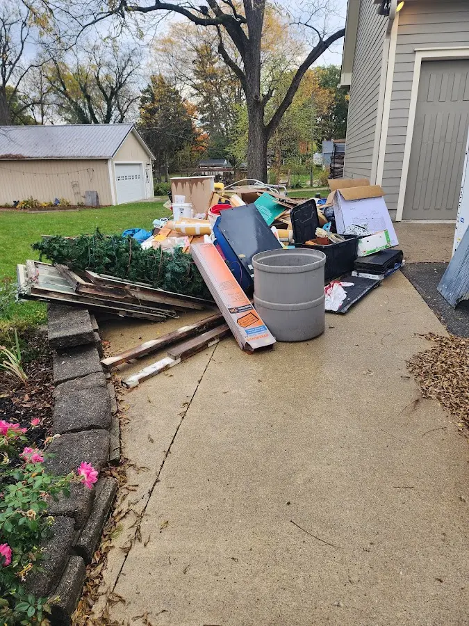 Dumpster being loaded with debris for Estate Cleanout Dumpster Rental in Hanover